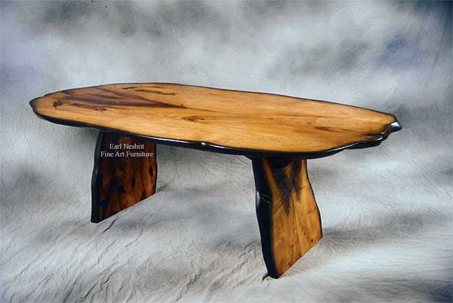 custom made natural edge dining table showing mesquite slab top with ebonized edge